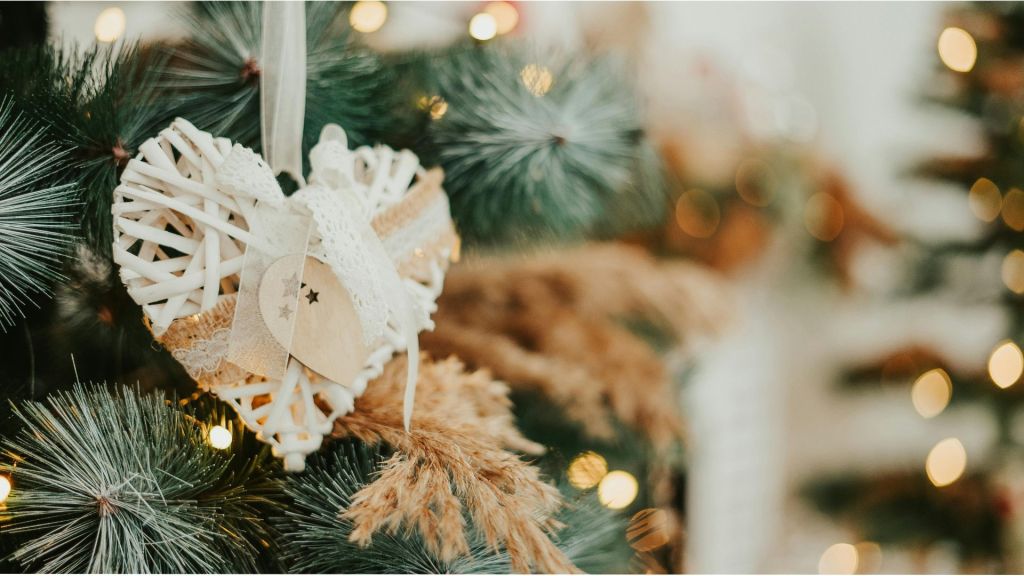 A white heart Christmas decoration on a CHhritmas tree