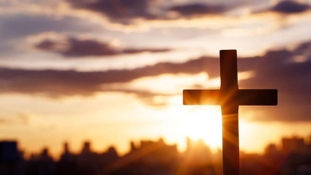 A cross at sunrise, symbolises Christianity, faith, religion